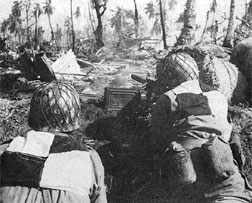 Action right in the foxholes and trenches was photographed as the battle raged. Infantrymen of the 7th handle machine guns.
