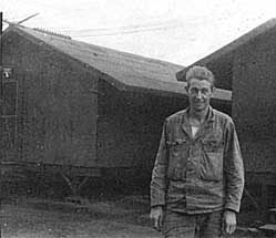 George A. Smith in front of camp area. Larger photo.